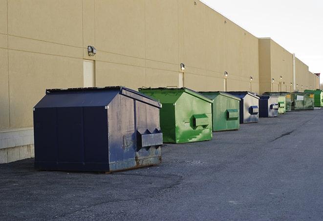 construction workers toss wood scraps into a dumpster in Blawnox PA